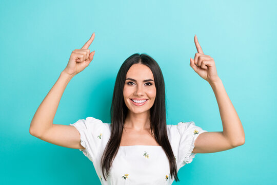 Photo of young nice woman model wearing white trendy crop top direct fingers up useful tips promoting isolated on cyan color background