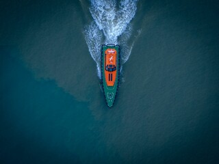 Aerial view of a pilot boat voyaging across a majestic blue body of water