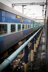 the passenger train is on the tracks at the station platform