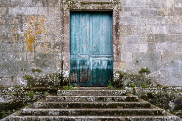 Staircase, stone facade and blue wooden door. Monastery of Santa María la Real de Osera, San...