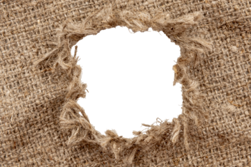 Hole in burlap. Torn piece of burlap fabric with a hole in the middle texture