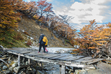 Couple crossing bridge, martial glacier, ushuaia, argentina