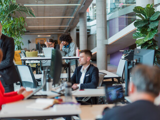 In a modern startup office, a diverse group of young professionals collaboratively tackles various business problems and challenges, surrounded by their engaged colleagues, fostering innovation and