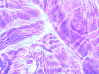 Purple wave abstracts or natural rippled water texture background Water waves in sunlight. Blurred transparent Purple colored clear calm water surface texture with splashes and bubbles.