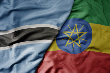 big waving national colorful flag of botswana and national flag of ethiopia .