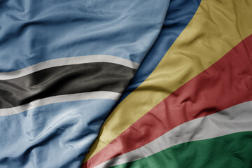Fototapeta premium big waving national colorful flag of botswana and national flag of seychelles .