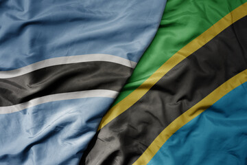 big waving national colorful flag of botswana and national flag of tanzania .