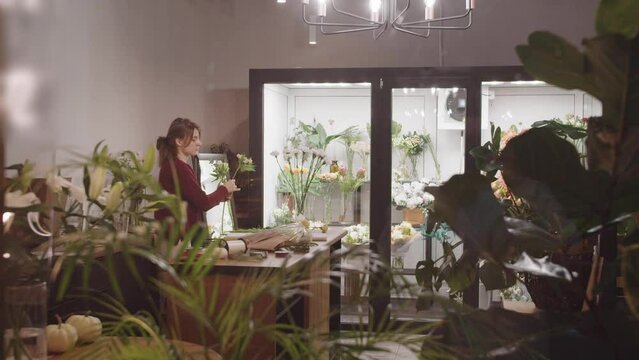A woman standing in a room with lots of flowers - business