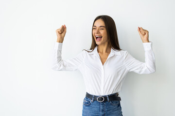 Excited woman reacting to win, screaming triumphing, achieve goal and celebrating, standing over white background - obrazy, fototapety, plakaty