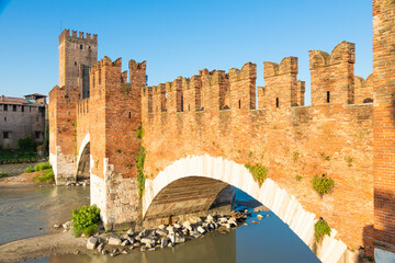 Verona, Italy. Castelvecchio bridge on Adige river. Old castle sightseeing at sunrise.