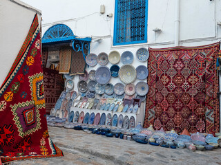 Souvenir earthenware and carpets in tunisian market, Sidi Bou Said, Tunisia.