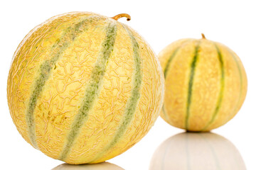 Two sweet cantaloupe melons, macro, isolated on white background.