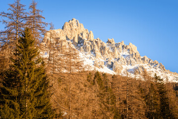 Majestic snow-capped rocky peak in the Alps in sunset light in winter