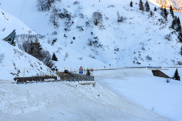 Icy mountain pass road in the Alps on a winter day