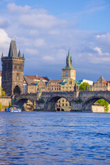 Charles Bridge (Karluv Most) on Vltava river and Old Town Bridge Tower, famous tourist destination in Prague, Czech Republic (Czechia), at sunset