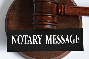 NOTARY MESSAGE - words on a black sheet against the background of a judge's gavel