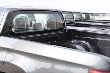 Obraz premium new grey SUV PICKUP vehicle, back view. Photography of a many, a lot modern pickup. made in Japan. parking in long perspective. back, rear view.