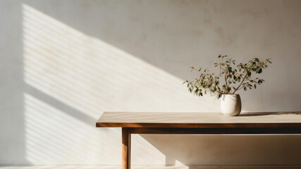 Wooden table and vase with eucalyptus plant in sunlight