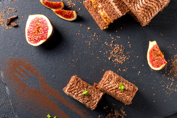 Chocolate cake cut into square pieces with nut cream