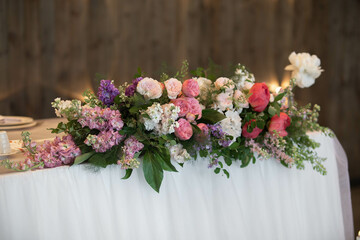 Main table at a wedding reception with beautiful flowers. Wedding decoations with pink flowers.