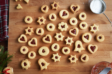 Linzer Christmas cookies filled with marmalade, ready to be dusted with sugar