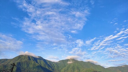 Obraz premium mountain landscape with clouds in the early morning sunshine. The sunshine is different in the spring morning on the remote side of Kirtipur.