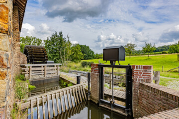 Closed water canal gate at old Eper or Wingbergermolen water mill, next Geul river, plain with...