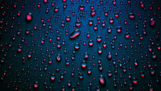 Water drops in neon lighting. Abstract background with colorful texture backdrop