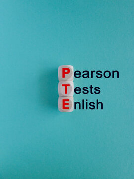 PTE - acronym on wooden cubes with red letters, Pearson Tests of English PTE concept Foreign Language exams.