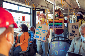 Activists with Protest Signs on Climate Change Riding a Bus