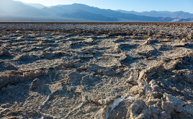 Salt desert, cracked crystalline salt. Dry cracked earth in Salt Flats, Death Valley