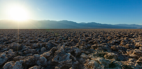 Salt desert, cracked crystalline salt. Dry cracked earth in Salt Flats, Death Valley