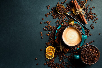 A cup of cappuccino and coffee beans. Top view, on a black background, free copy space. Robusta or Arabica.