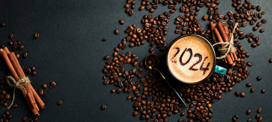 Cup of cappuccino with cinnamon. New Year's decor. Numbers 2024. On a dark background.