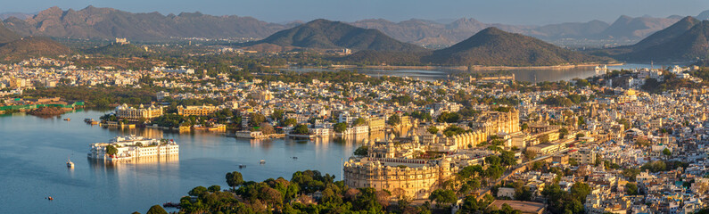 Panoramic aerial view of Udaipur city also known as city of lakes from Karni Mata Temple, Rajasthan. Udaipur city is a popular honeymoon destination among tourist in India. - obrazy, fototapety, plakaty