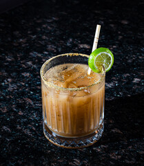 fresh and salty cocktail with ice on a black background