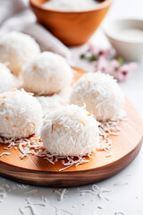 Fototapeta na wymiar Coconut balls dessert with coconut flakes. Generative AI,