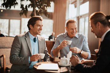 Businessmen Engaged in Discussion Over Coffee