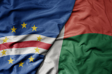 big waving national colorful flag of cape verde and national flag of madagascar.
