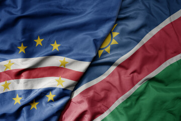 big waving national colorful flag of cape verde and national flag of namibia .