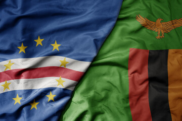 big waving national colorful flag of cape verde and national flag of zambia .