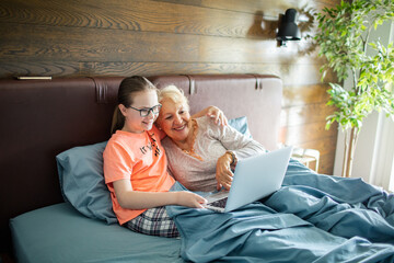 Grandmother and Granddaughter Enjoying Time Together with a Laptop