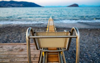 Motorized chair that helps disabled people swim in the sea without assistance.