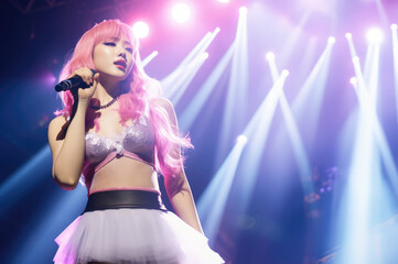 Beautiful Korean K-pop singer girl singing on live stage wearing silver bikini bra in spotlights with copy space