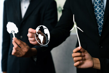 Group of business people holding alternative net zero energy icon for greener sustainable Earth...