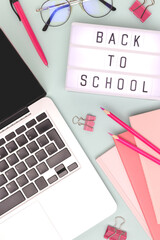Back to school. Workspace with lightbox, laptop and stationery on a blue background. Online education concept.