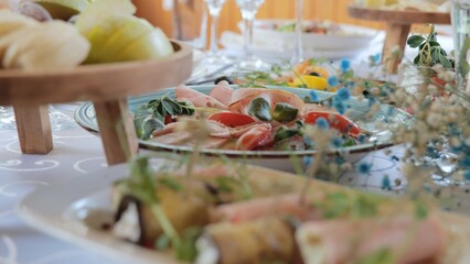 A beautiful festive table covered with a variety of food. Food and drinks on the festive table in the restaurant on birthdays, weddings. Beautifully decorated banquet table with appetizers.