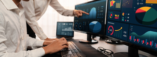 Analyst working on data analysis or BI dashboard on computer monitor. Business team analyzing...
