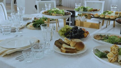 Snack table. Canape with vegetables and cheese, Served table with food. Lots of snacks on the holiday table. Banquet with snacks, cheese and fruits, canapes, salads, appetizers on the festive table.
