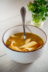 hot vegetable soup with large pasta in a bowl